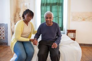 aging senior holding hands with a loved one